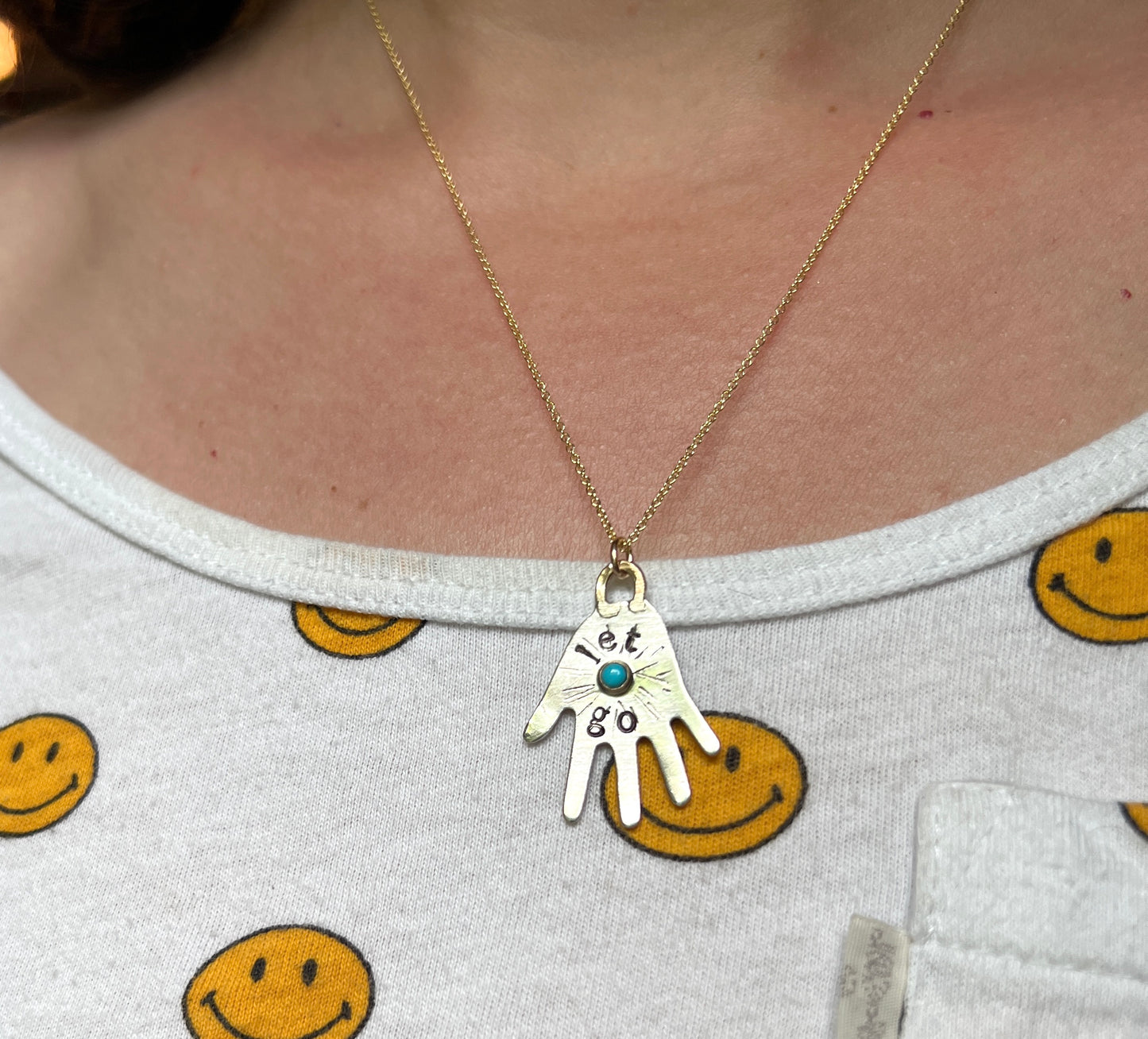 Let Go sterling silver hand pendant with turquoise pendant